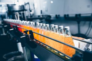 6003 Linha automatizada em indústria de alimentos e bebidas com produtos em esteira de produção.